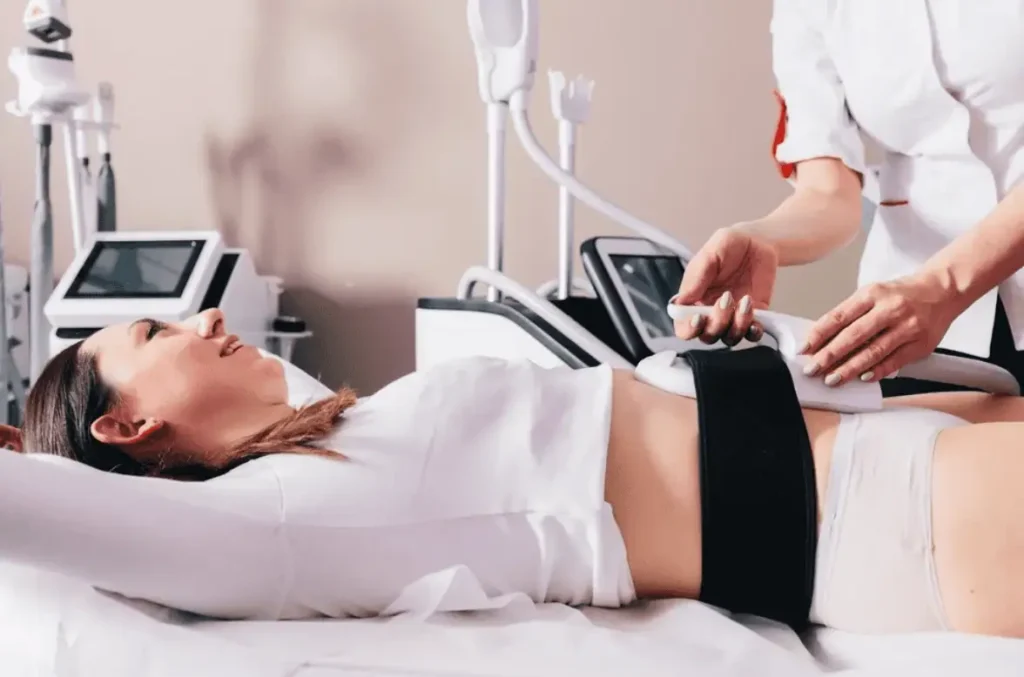 Professional administering Emsculpt Neo body contouring treatment on a client’s abdomen in Provo, Utah