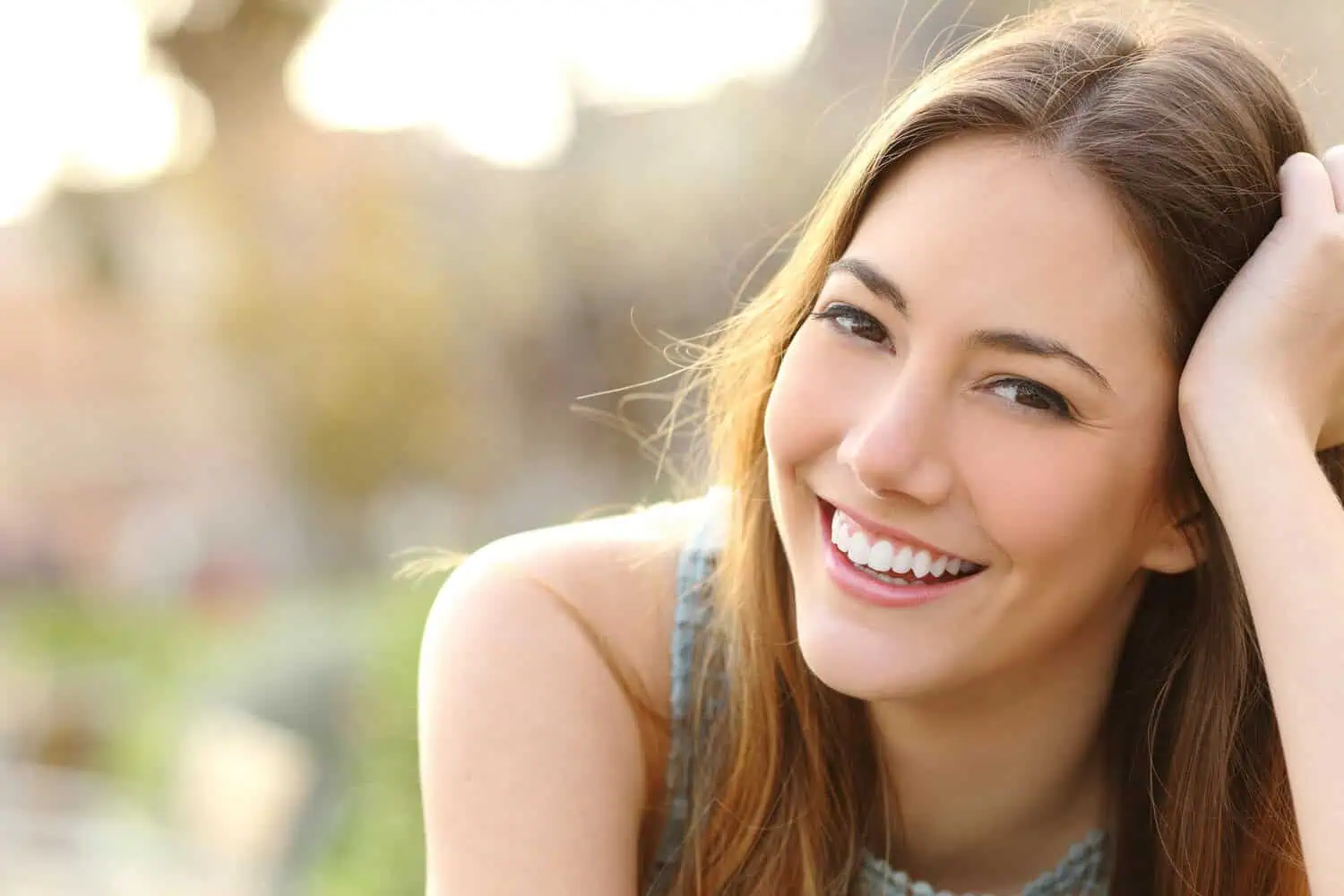Young woman relaxing outdoors, representing balanced hormones with BHRT therapy benefits in Provo, UT.