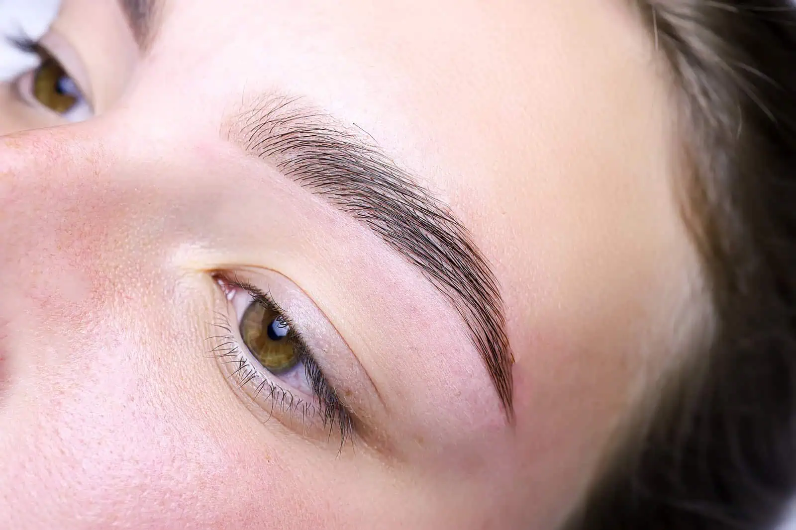 photo of brow lamination and waxing showing groomed, lifted eyebrows in Provo, UT.