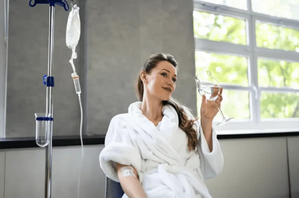 Woman relaxing in a robe and receiving IV therapy hydration treatment at a clinic in Provo, Utah