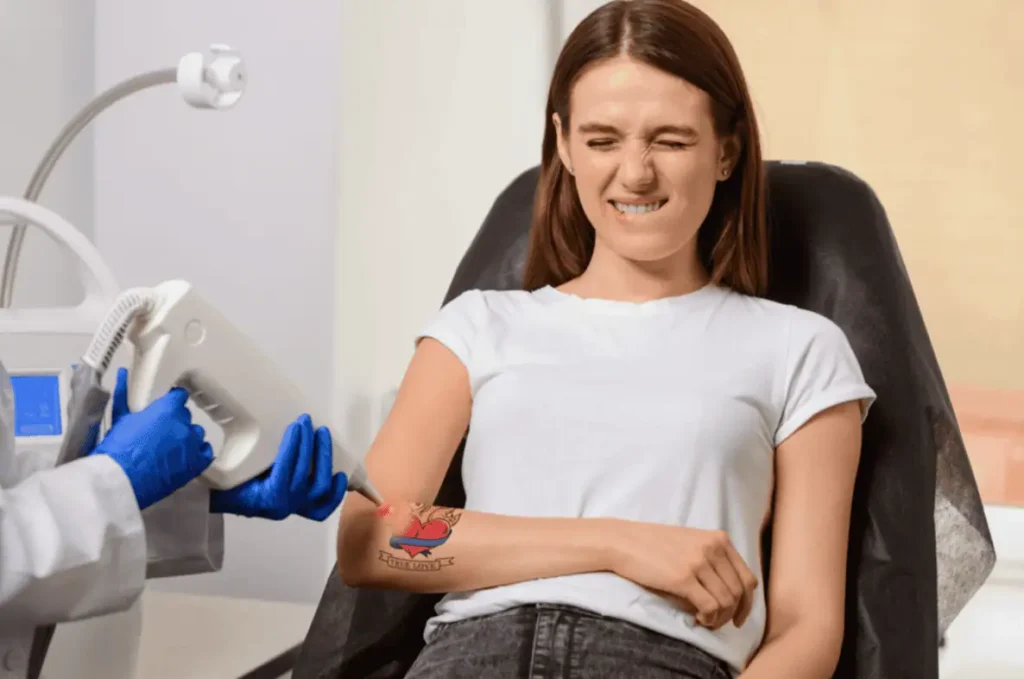 Specialist using advanced pain management techniques during laser tattoo removal in Provo, Utah
