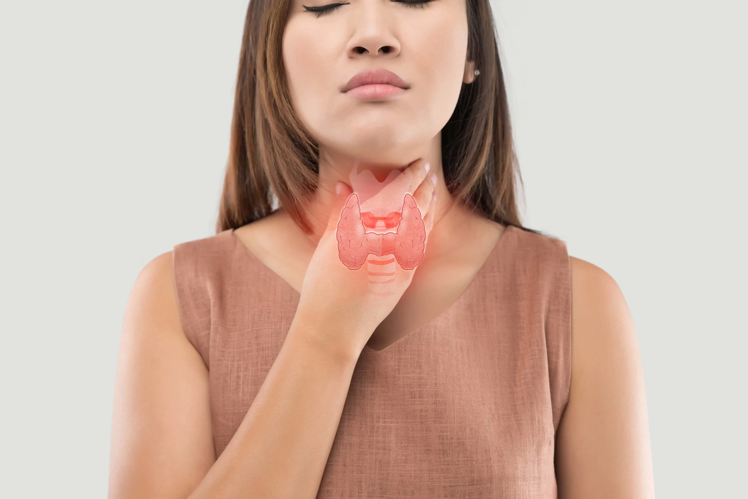 Woman showing thyroid gland location representing thyroid function and hormone health care