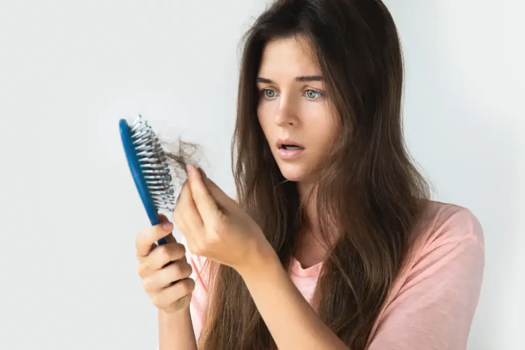 Early signs of hair thinning in brush before air restoration treatment.