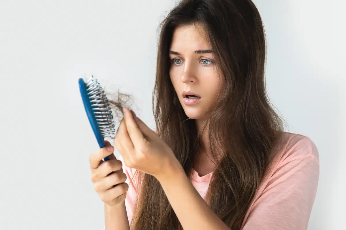 Early signs of hair thinning in brush before air restoration treatment.